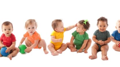 Babies in rainbow colored outfits